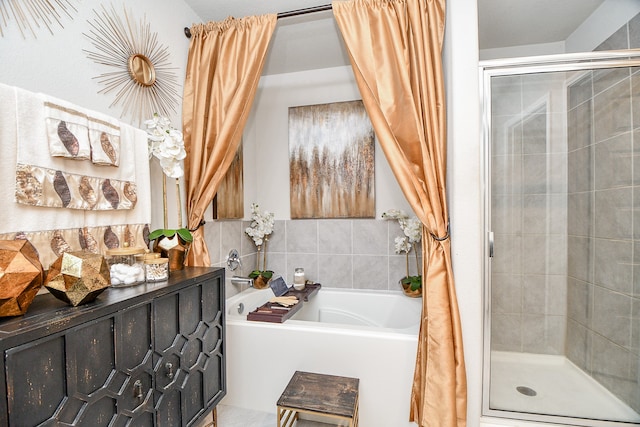 bathroom featuring shower with separate bathtub