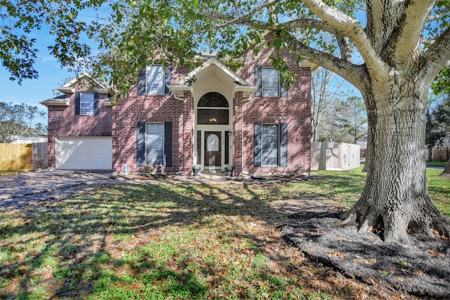 view of front of property featuring a front yard and a garage