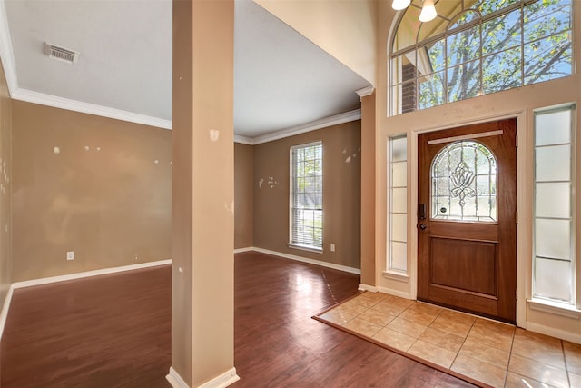 entrance foyer featuring wood-type flooring and ornamental molding