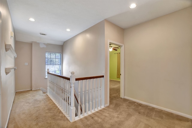 hallway with light colored carpet