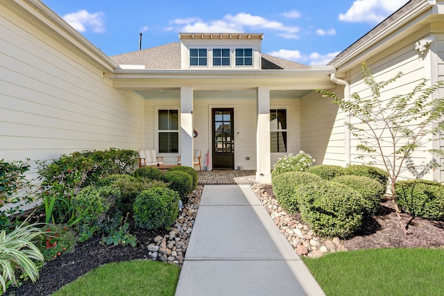 view of exterior entry with covered porch