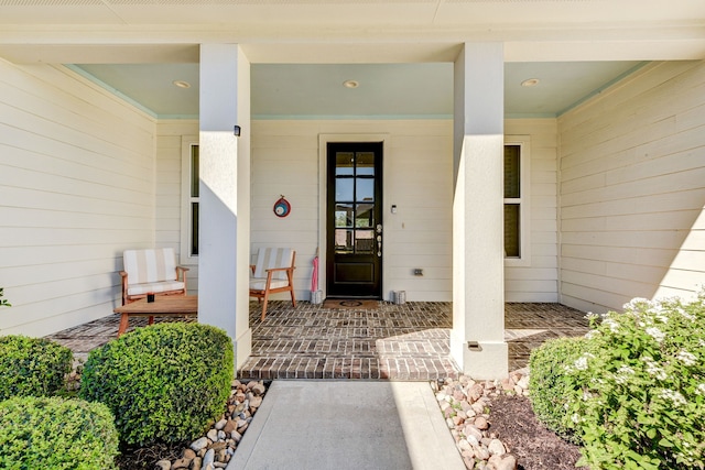 entrance to property featuring a porch