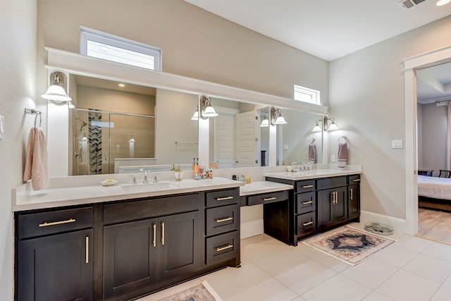 bathroom with tile patterned flooring, vanity, and a shower with shower door