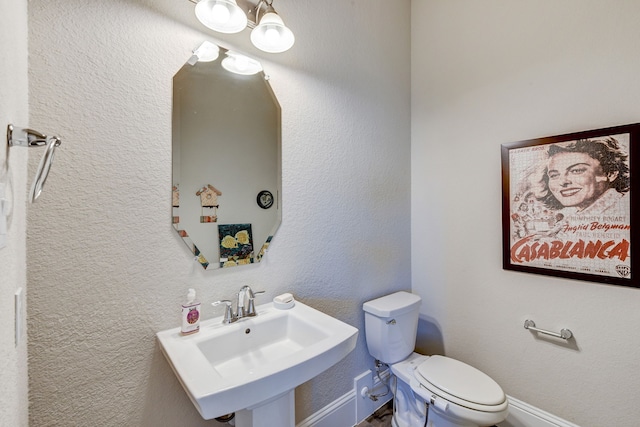 bathroom featuring sink and toilet