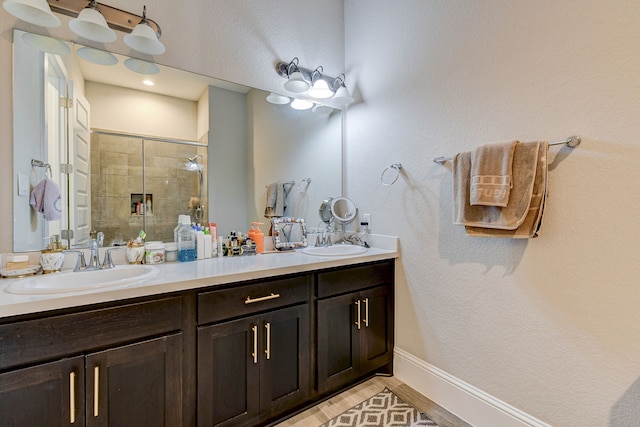 bathroom with hardwood / wood-style floors, vanity, and a shower with shower door