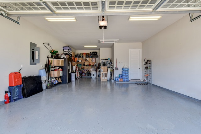 garage with a garage door opener and electric panel