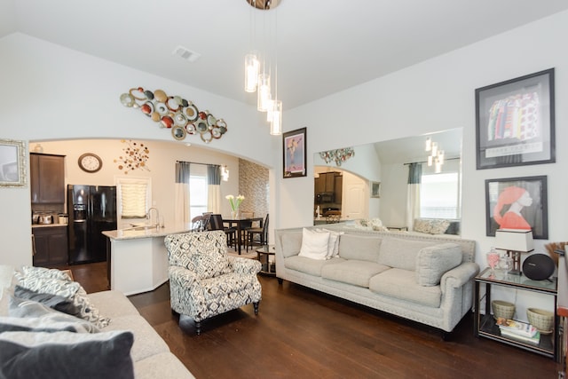 living room with dark hardwood / wood-style floors and vaulted ceiling