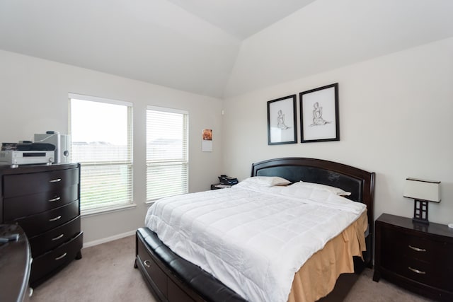 bedroom featuring light colored carpet and lofted ceiling