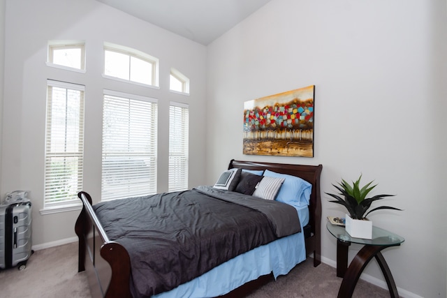 carpeted bedroom featuring multiple windows