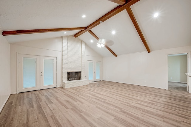 unfurnished living room featuring a fireplace, french doors, and light hardwood / wood-style floors