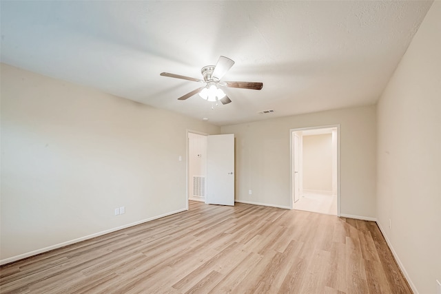 empty room with light hardwood / wood-style flooring and ceiling fan