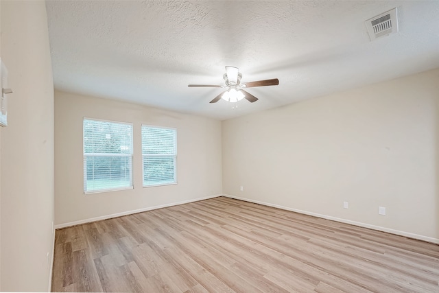 unfurnished room with a textured ceiling, light hardwood / wood-style floors, and ceiling fan