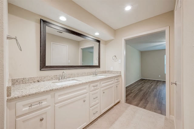 bathroom featuring vanity and wood-type flooring