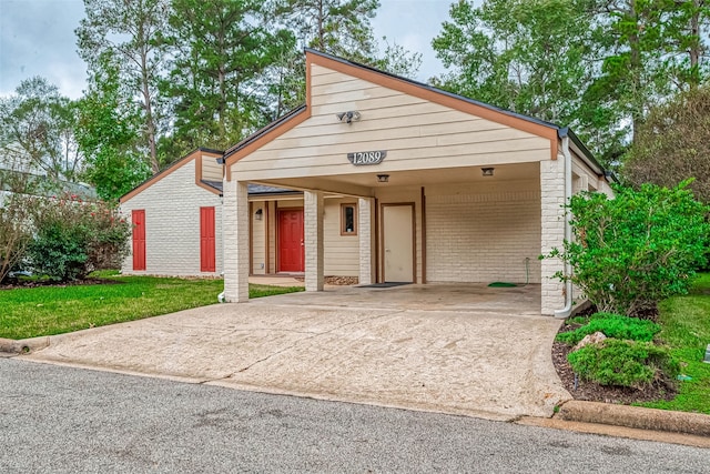 view of front of property with a front yard and a carport