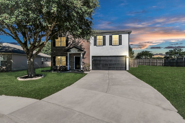 view of front of property featuring a lawn and a garage