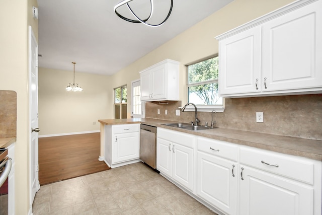 kitchen with appliances with stainless steel finishes, decorative light fixtures, a wealth of natural light, and sink