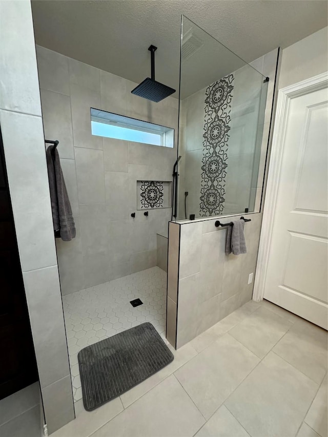 bathroom with tile patterned flooring and walk in shower