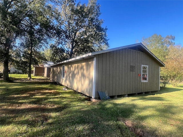 view of outbuilding with a lawn