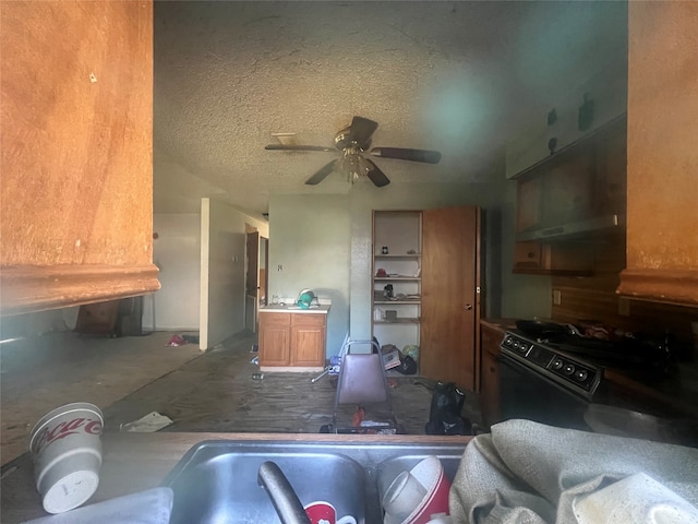 kitchen featuring concrete flooring, black stove, a textured ceiling, and ceiling fan