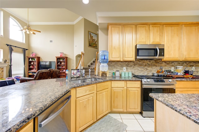 kitchen with ceiling fan, sink, stainless steel appliances, crown molding, and light tile patterned floors