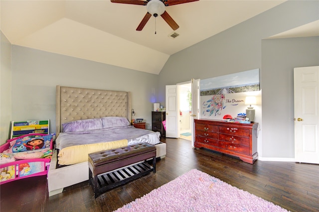 bedroom featuring dark hardwood / wood-style flooring, ensuite bathroom, vaulted ceiling, and ceiling fan