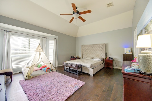 bedroom with vaulted ceiling, ceiling fan, and dark wood-type flooring