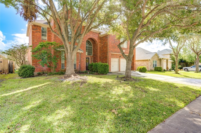 view of front of property featuring a garage and a front lawn