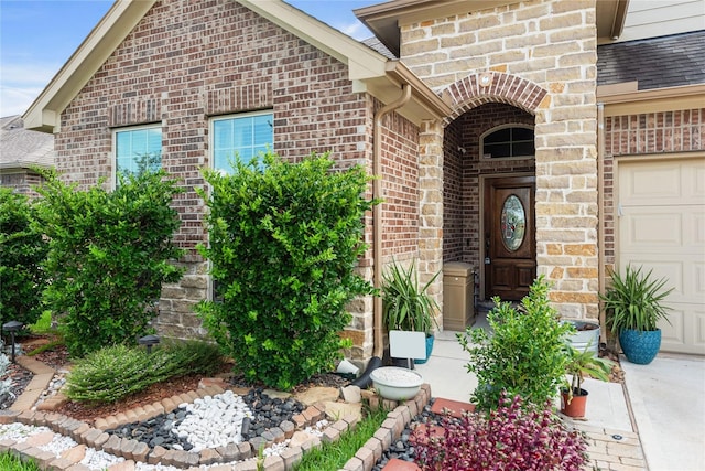 doorway to property with a garage