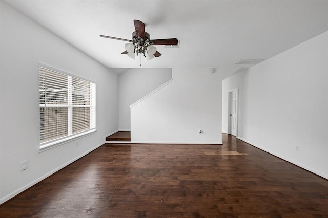 unfurnished living room featuring ceiling fan and dark hardwood / wood-style flooring