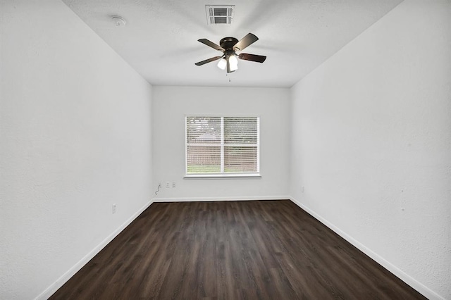 empty room featuring ceiling fan and dark wood-type flooring