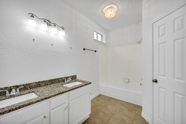 bathroom with vanity, a textured ceiling, bathing tub / shower combination, and tile patterned flooring