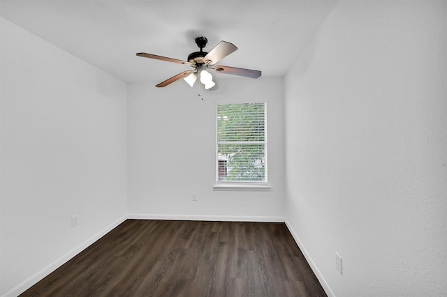 empty room featuring dark hardwood / wood-style flooring and ceiling fan