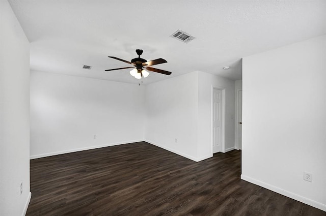 spare room with ceiling fan and dark wood-type flooring