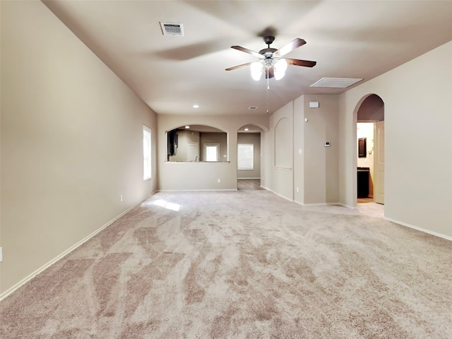 unfurnished living room with ceiling fan and light carpet