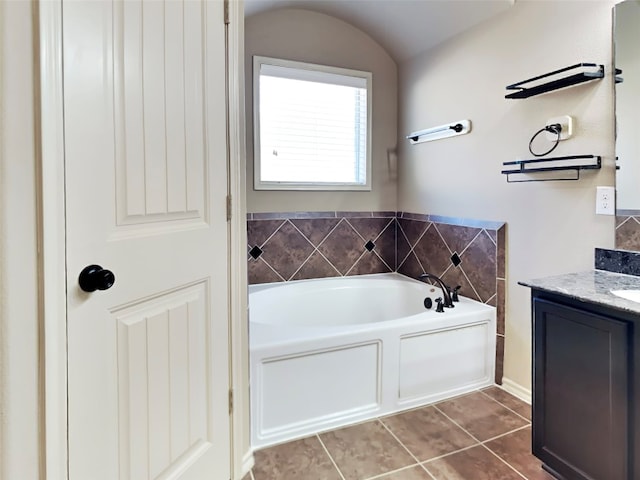 bathroom featuring tile patterned flooring, vanity, and a bathing tub