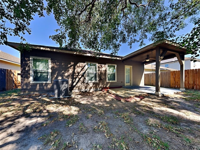 back of property featuring ceiling fan and a patio area