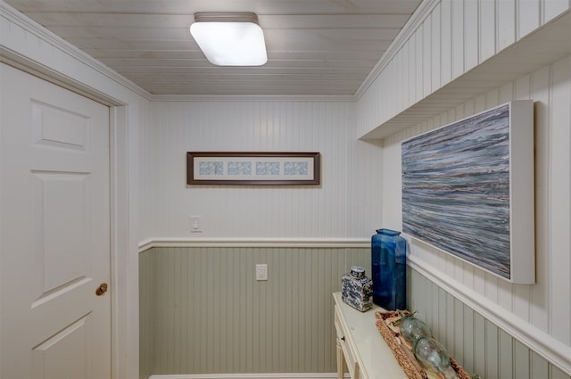 laundry area featuring wooden walls and ornamental molding