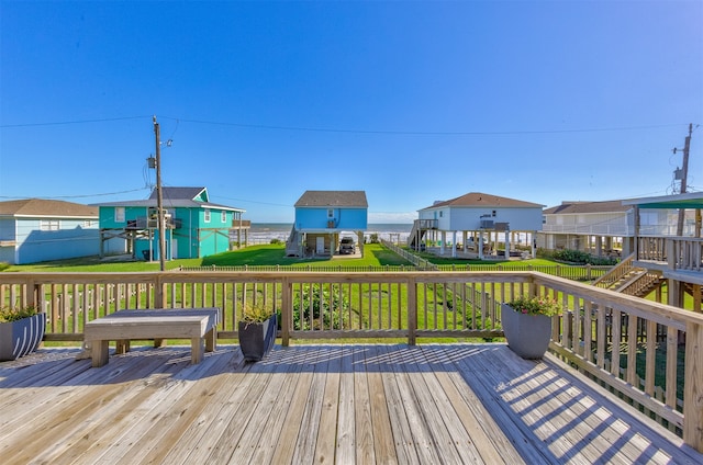 deck with a yard and a water view