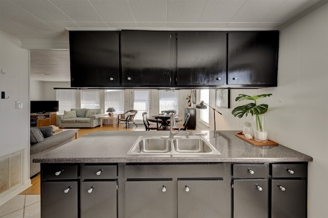 kitchen featuring light tile patterned flooring and sink