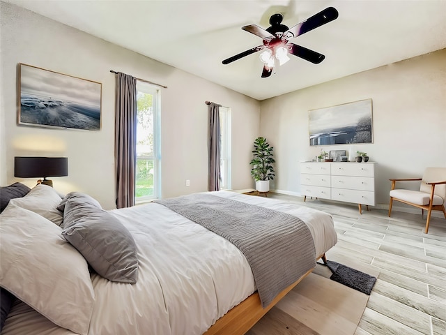 bedroom with light wood-type flooring and ceiling fan