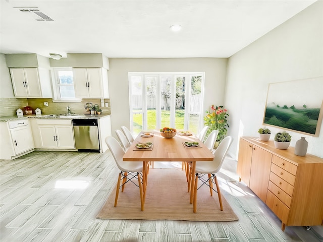 dining space featuring sink and light hardwood / wood-style floors