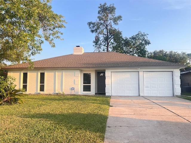 single story home featuring a front lawn and a garage