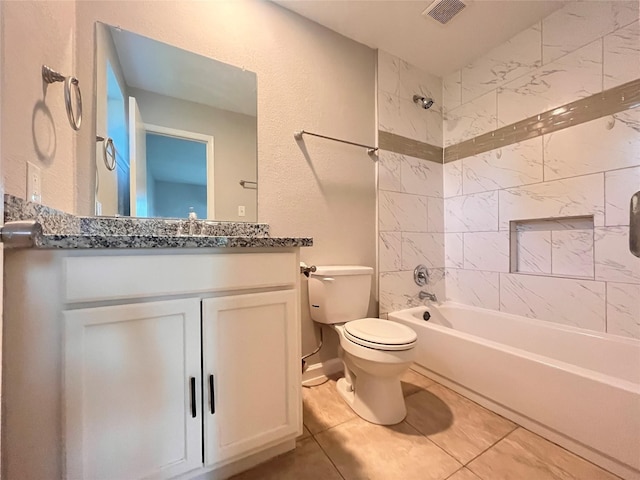 full bathroom with tile patterned floors, vanity, toilet, and tiled shower / bath combo