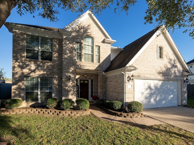 view of front of property with a garage and a front lawn