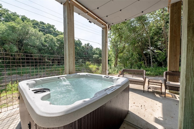 view of swimming pool with a hot tub