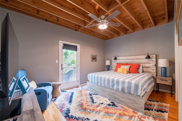 bedroom with access to exterior, ceiling fan, light hardwood / wood-style flooring, beamed ceiling, and wood ceiling