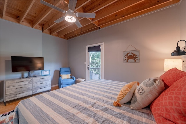 bedroom featuring hardwood / wood-style floors, wooden ceiling, access to outside, ceiling fan, and beamed ceiling