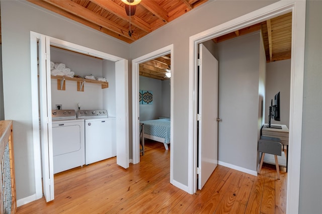 laundry area featuring ceiling fan, washing machine and dryer, wood ceiling, and light hardwood / wood-style flooring