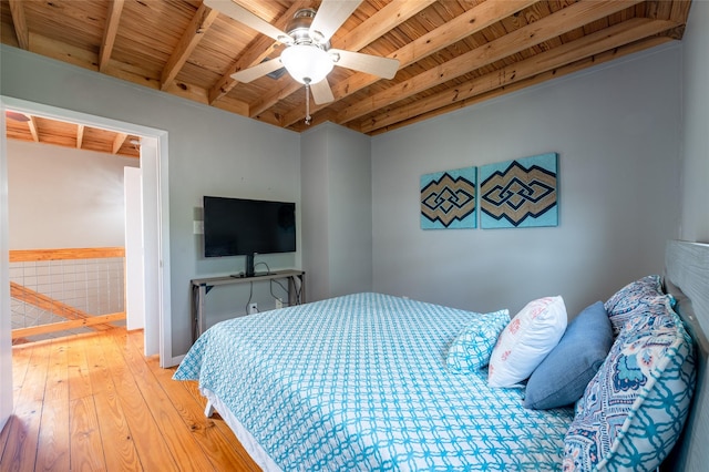 bedroom with light hardwood / wood-style floors, ceiling fan, beam ceiling, and wood ceiling