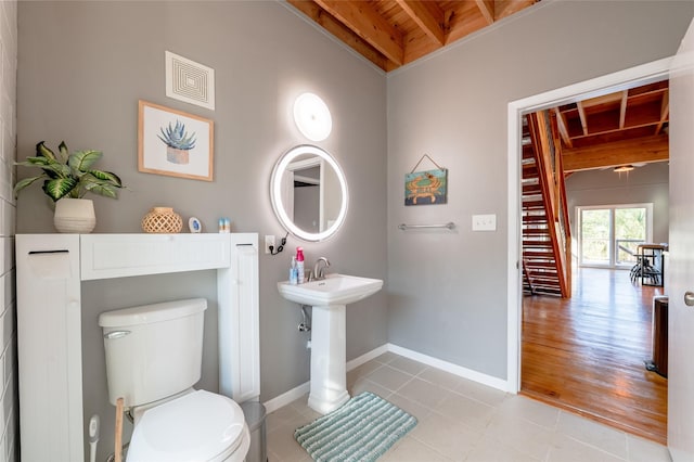 bathroom featuring beamed ceiling, hardwood / wood-style flooring, toilet, and wooden ceiling